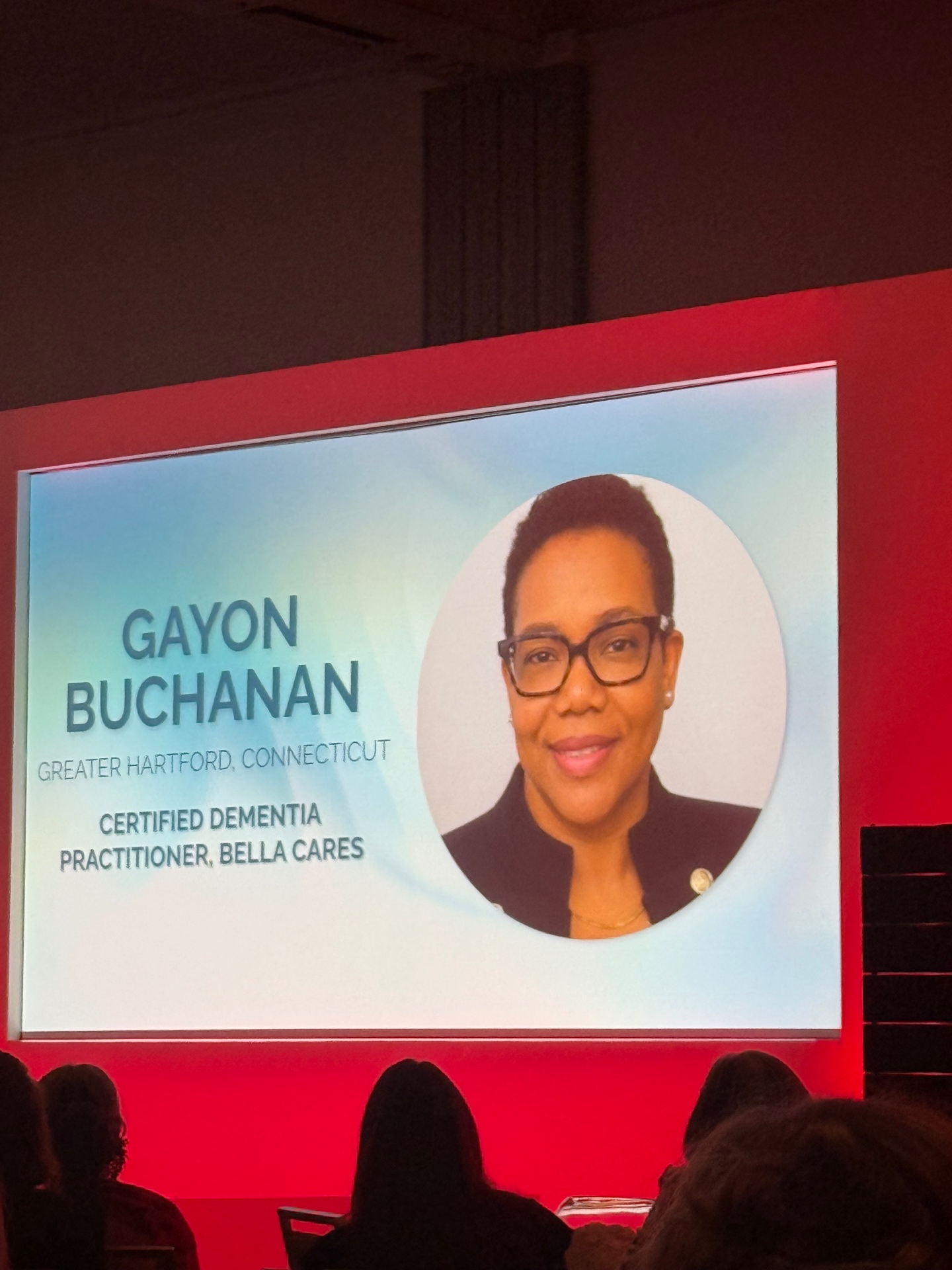 Gayon Buchanan featured on the main stage screen as a certified dementia practitioner with Bella Cares