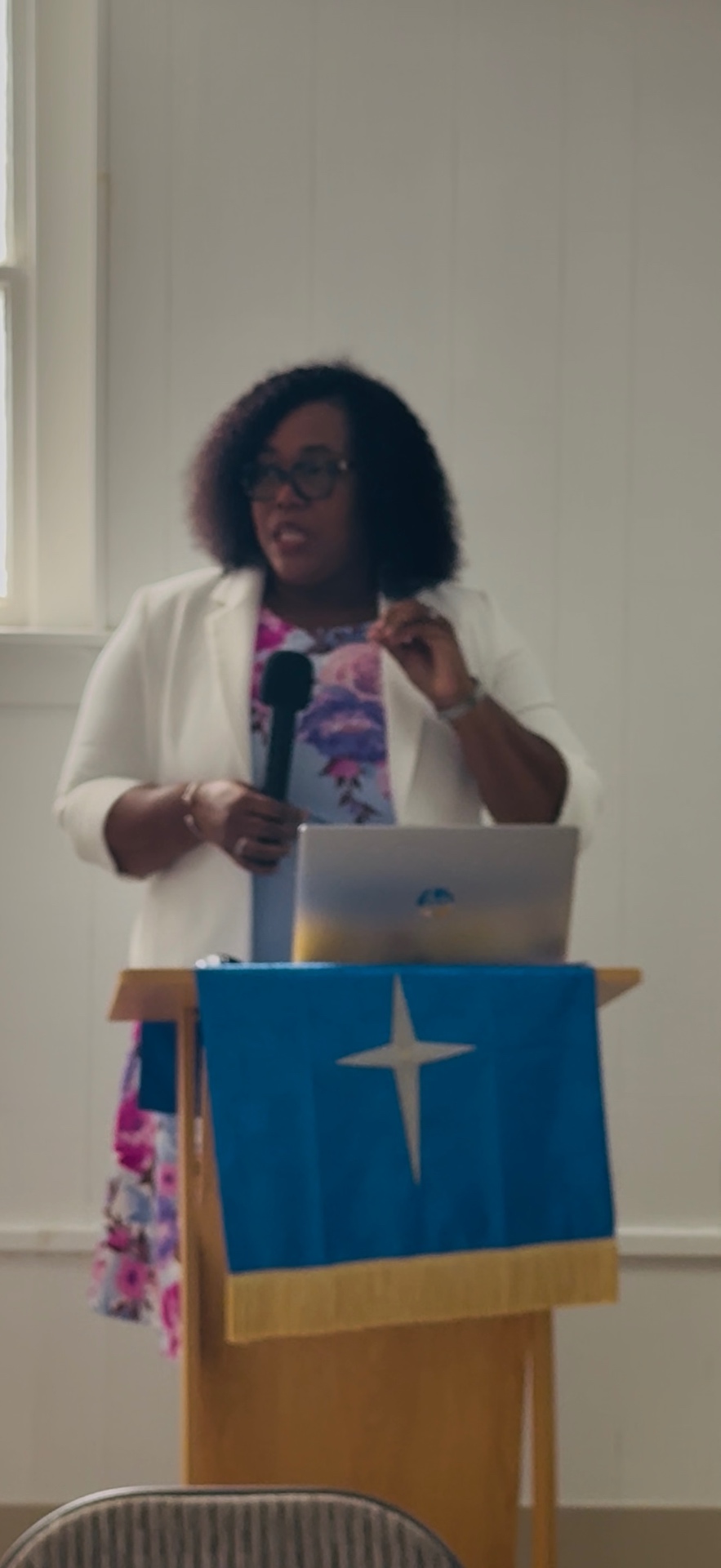 Gayon Buchanan speaking at a podium during a dementia education presentation